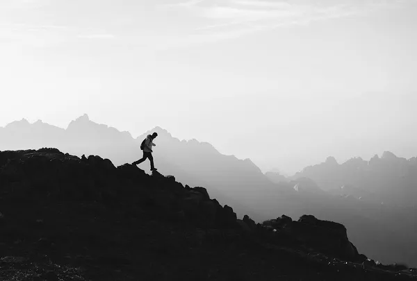 A lone figure on a mountain ridge